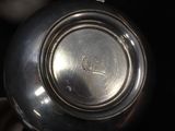 a close up of a silver tea pot on a table