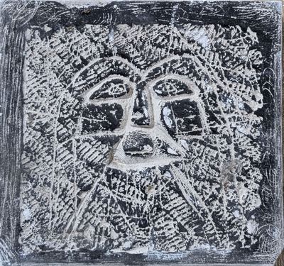 a black and white picture of a face in the snow