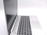 a laptop computer that is sitting on a white surface