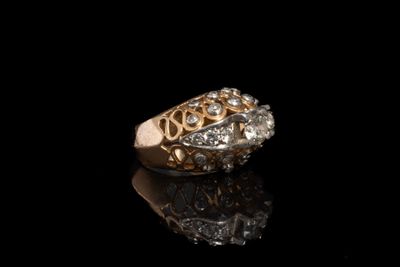 une image d'une bague en or et en diamant sur une surface noire
