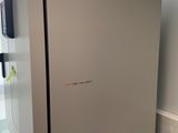 a refrigerator that is sitting on a counter next to a window