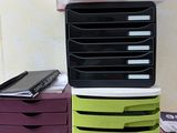 many boxes stacked on top of each other on a desk