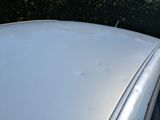 a close up of a car ' s roof with a lot of scratches on it