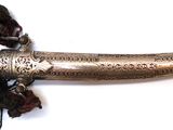 a very old dagger that is on display on the table