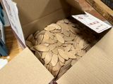 a cardboard box filled with lots of wooden spoons