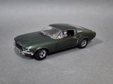 a green toy car with a man in the driver seat