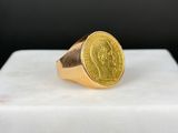 l'image d'un anneau d'or surmonté d'une pièce de monnaie
