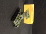 a small toy tank sitting next to a yellow box on a black surface