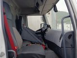 a white truck with a red seat and a black seat