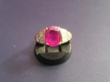 an image of a ring with a pink stone in it
