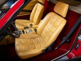yellow leather seats in a red sports car in a garage