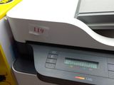 a printer that is sitting next to a yellow box
