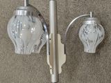 a light that is on the wall next to a lamp