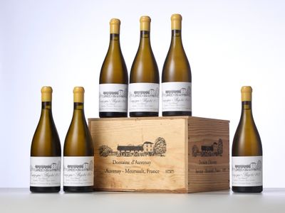 six bottles of white wine in a wooden box on a table