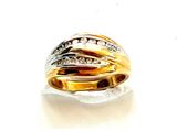 une bague en or sertie de diamants, posée sur une surface blanche