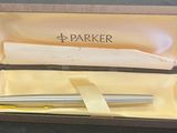 a pen in a box that is open on a table
