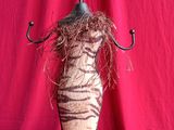 a zebra print vase with a tree on top of it