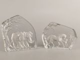 pair of clear glass elephant bookends on a white surface