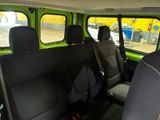 a green van with black seats in the back of it