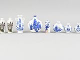 several blue and white vases are lined up on a white surface