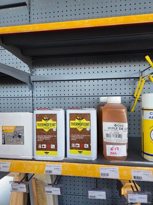 many different types of paint on the shelves in the store