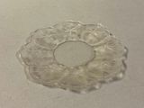 a small piece of glass on a table next to a cup