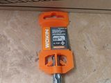 an orange tool that is laying on the floor