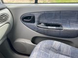 the interior of a car with the door open and the seat up