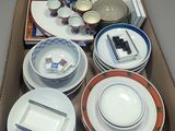 a box with a variety of plates and bowls in it