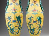 pair of yellow vases with blue and green designs on them