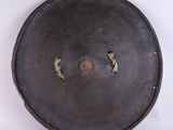 a large metal plate with holes in the middle of it