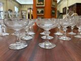 many empty wine glasses sitting on a table in a room