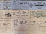 several old french bank notes on a wooden table