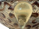 a glass bowl with a liquid inside of it on a table
