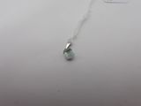 a necklace with a blue topaz stone on a silver chain