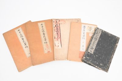 plusieurs vieux livres sont empilés sur une surface blanche