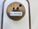a close up of a metal object with a label on it