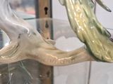 a close up of a figurine of a fish in a glass case