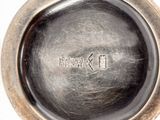 a close up of a silver plate with a logo on it