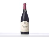 a bottle of red wine sitting on top of a table