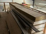 several pieces of wood are stacked up in a warehouse