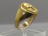 an image of a gold signet ring on a clear stand