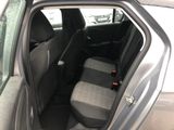 the back seat of a car with the door open and the driver ' s seat down