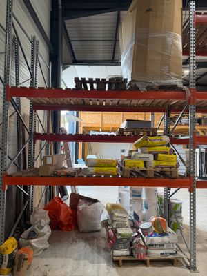 a shelf with a lot of items on it in a warehouse