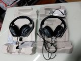 pair of black headphones sitting on top of a white tray