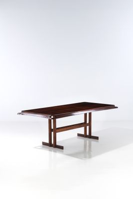 the table is made of wood and has a rectangular top