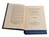 an open book on a white surface with a blue cover