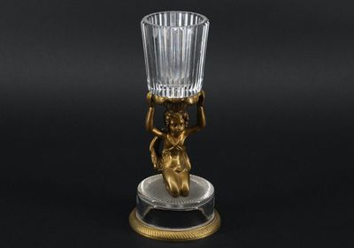 a close up of a glass vase with a statue on it