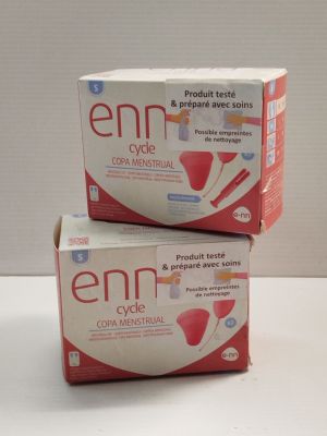 two boxes of emmi breast milk sitting on top of a white table