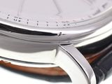a close up of a watch on a white surface
